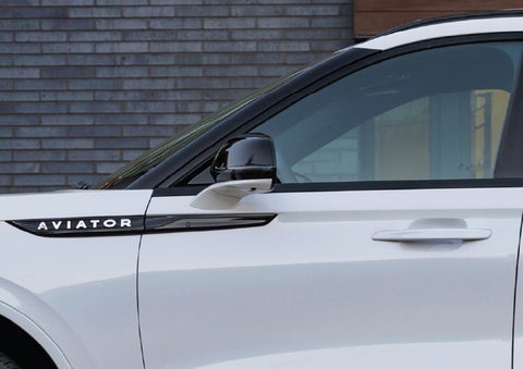 The driver’s side door and fender badging of a white 2026 Lincoln Aviator® SUV are showcased. | Crest Lincoln in Sterling Heights MI