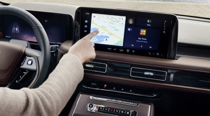 A person is tapping the center display touchscreen of a 2026 Lincoln Aviator® SUV. | Crest Lincoln in Sterling Heights MI