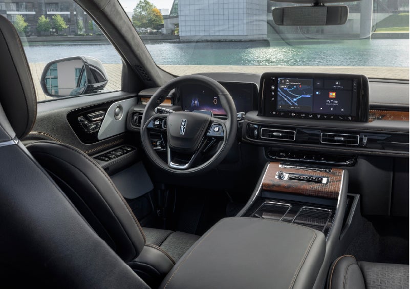 The interior of the 2026 Lincoln Aviator® SUV is shown parked with a view of a harbor through the windshield. | Crest Lincoln in Sterling Heights MI