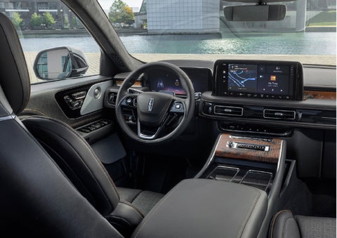 The interior of the 2026 Lincoln Aviator® SUV is shown parked with a view of a harbor through the windshield. | Crest Lincoln in Sterling Heights MI
