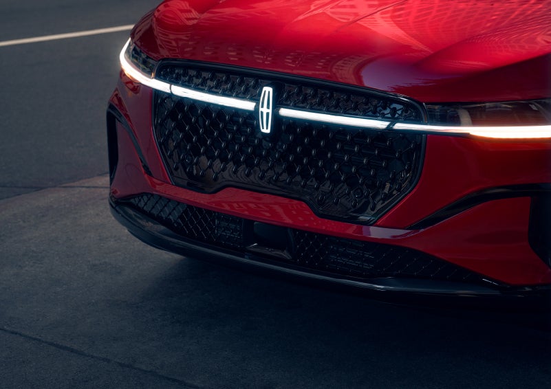 The available front LED light bar and center Lincoln Star logo glow at dusk. | Crest Lincoln in Sterling Heights MI