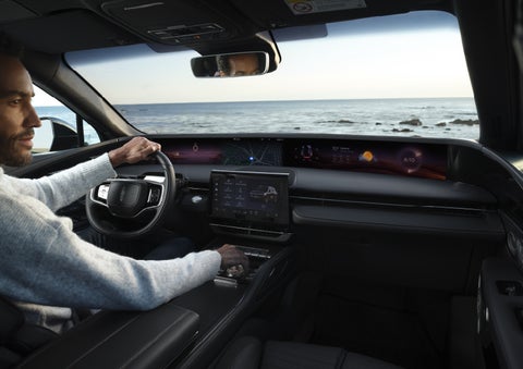 A driver of a parked 2026 Lincoln Nautilus® SUV takes a relaxing moment at a seaside overlook while inside his Nautilus. | Crest Lincoln in Sterling Heights MI