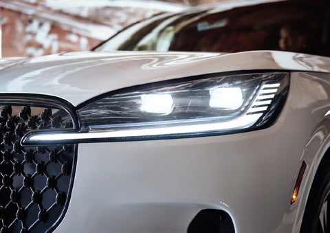 A close-up of a headlamp on the 2027 Lincoln Aviator® SUV is shown. | Crest Lincoln in Sterling Heights MI