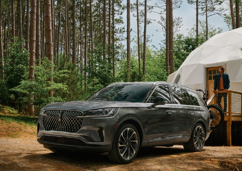 A 2027 Lincoln Aviator® is parked next to a high end glamping site. | Crest Lincoln in Sterling Heights MI
