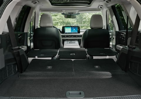A rear to front view of the interior of a 2027 Lincoln Aviator® Black Label™ SUV shows the third and second rows folded flat | Crest Lincoln in Sterling Heights MI