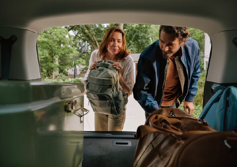 A couple loads luggage into the rear of a 2027 Lincoln Aviator® Black Label™ SUV..e 202 | Crest Lincoln in Sterling Heights MI