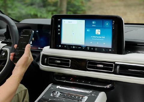 A person pairs thier phone with the center touchscreen of a 2027 Lincoln Aviator® Black Label™ SUV | Crest Lincoln in Sterling Heights MI