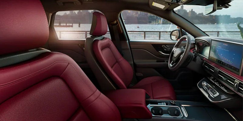 Luxurious red leather car interior with waterfront view