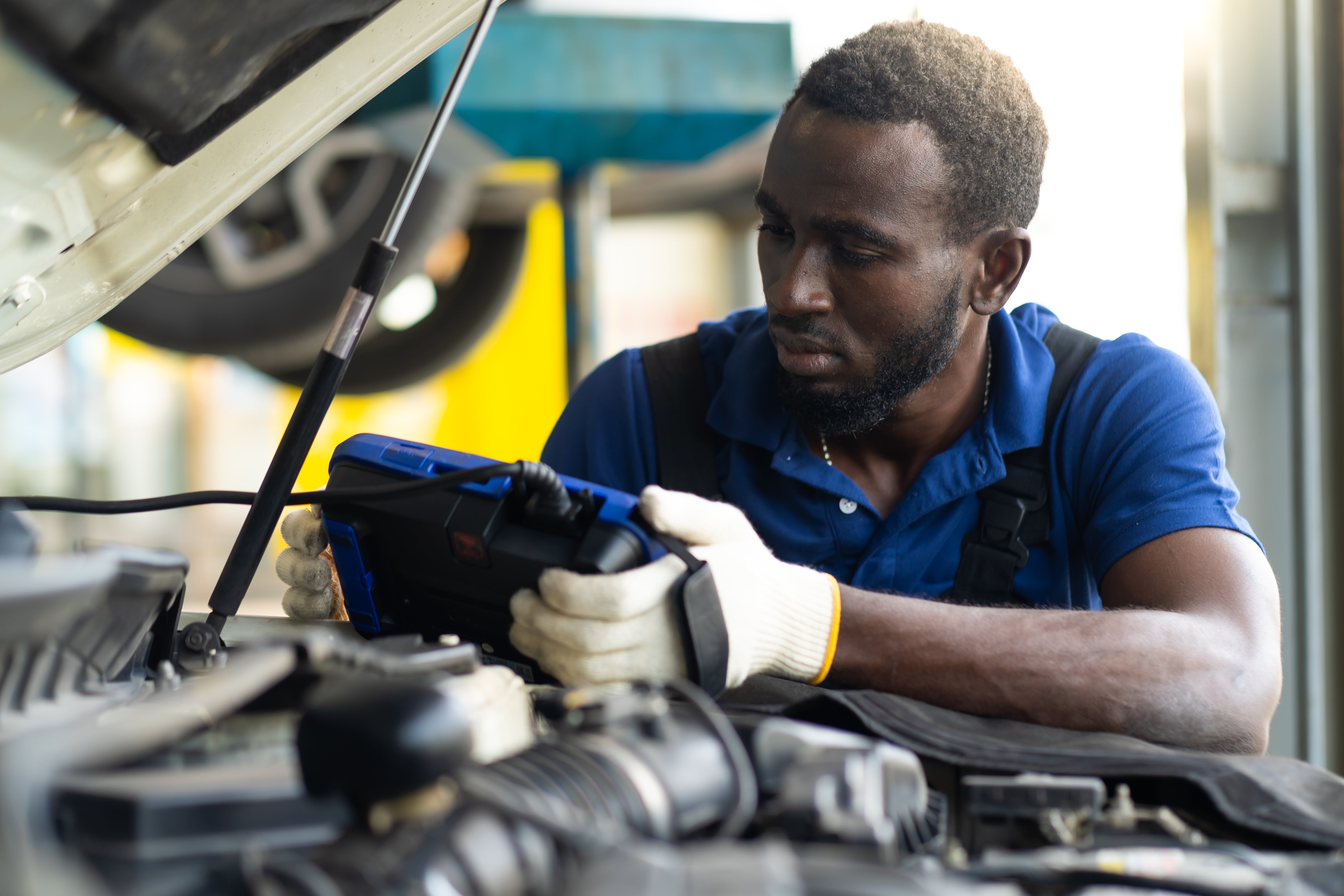 A technician reading a diagnostic tool during a Lincoln maintenance appointment